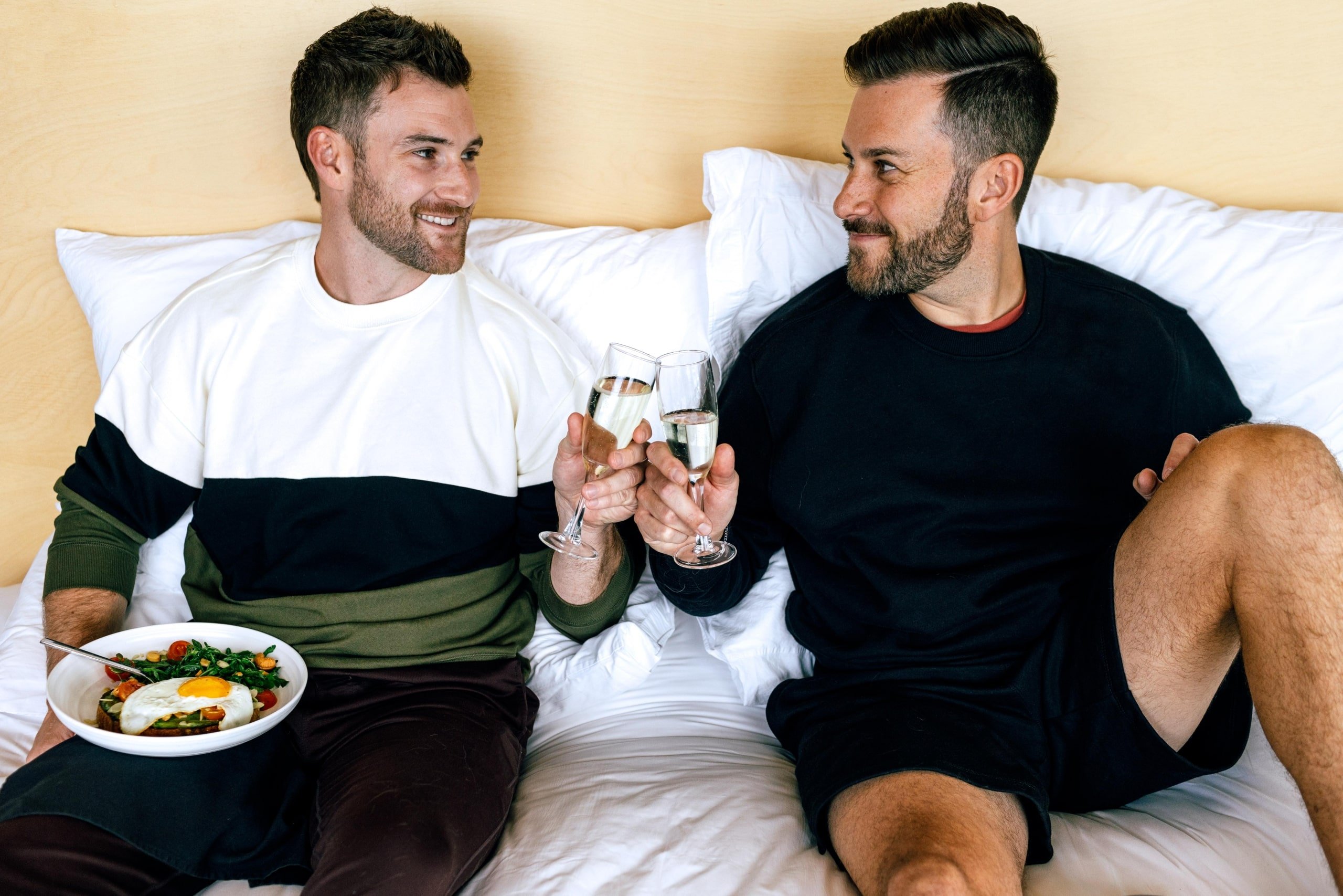 couple relaxing eating in bed